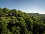 This end of road eco-friendly home is nested into the hillside with ultimate privacy and unbelievable views